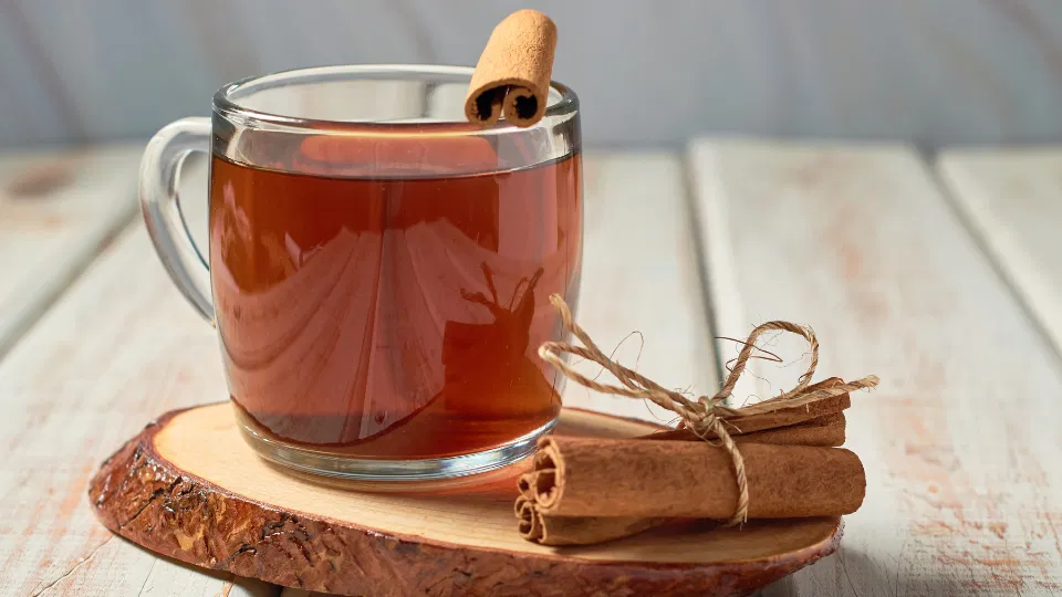 A warm drink with cinnamon on a kitchen table, representing a simple daily habit for well-being